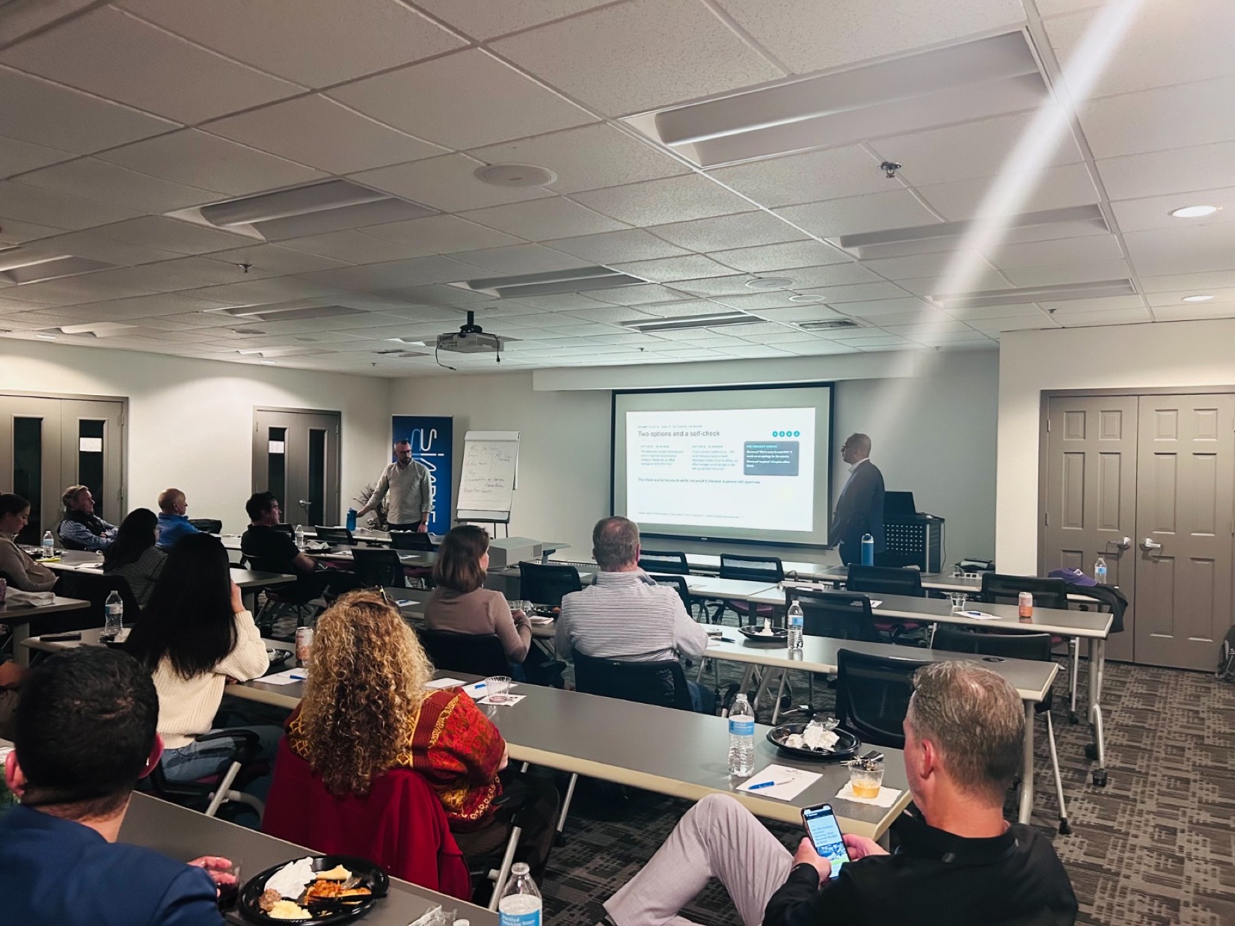 Dentists at a Milwaukee study group, October 15, 2026. Dr. Raison Bose is at the screen. Gary Spagnoli is at the front of the room.
